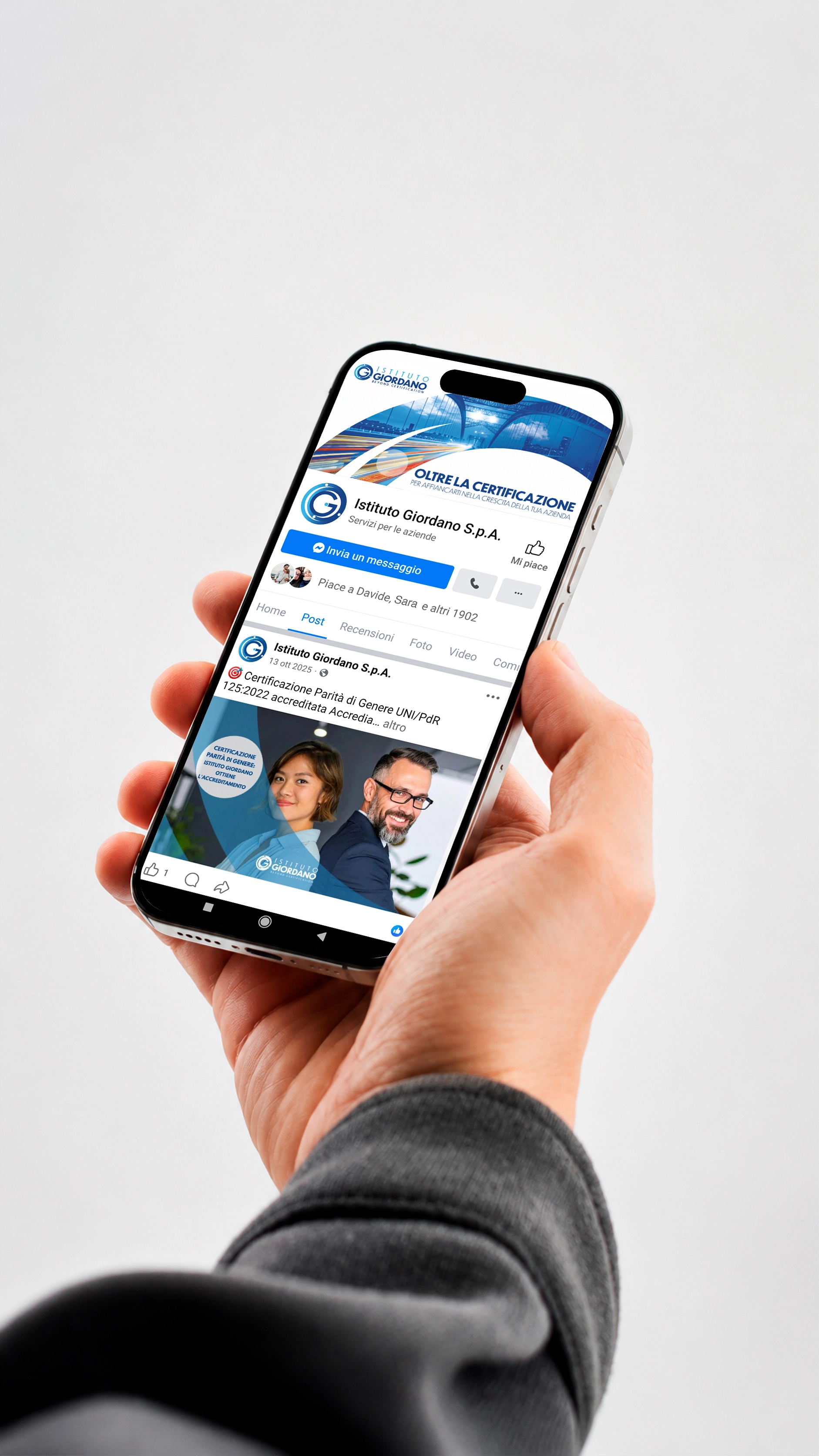 Smartphone in mano con la pagina Facebook di Istituto Giordano